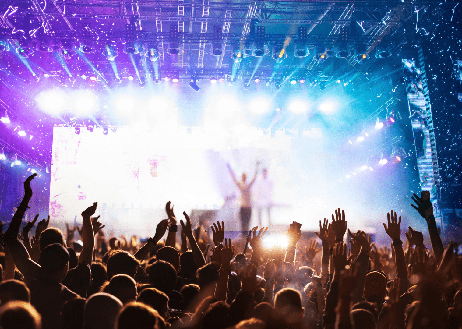 Image of a dj at a festival in barcelona with the stage full of people. 