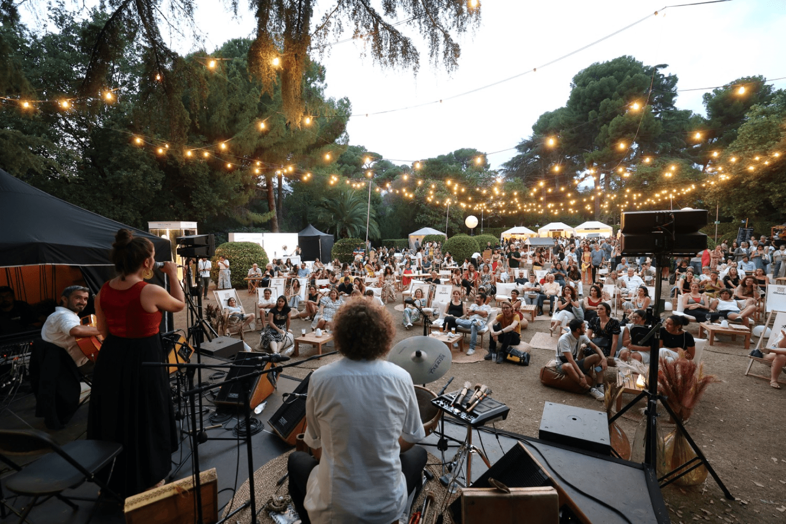 Image of a band at the Les Nits festival in Barcelona with people enjoying their music.